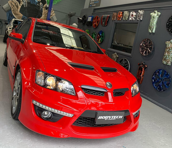 Hail damage reapir of red Holden in Sydney