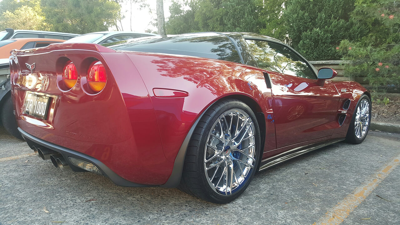 Side angle of red Corvette ZR1 in for detailing