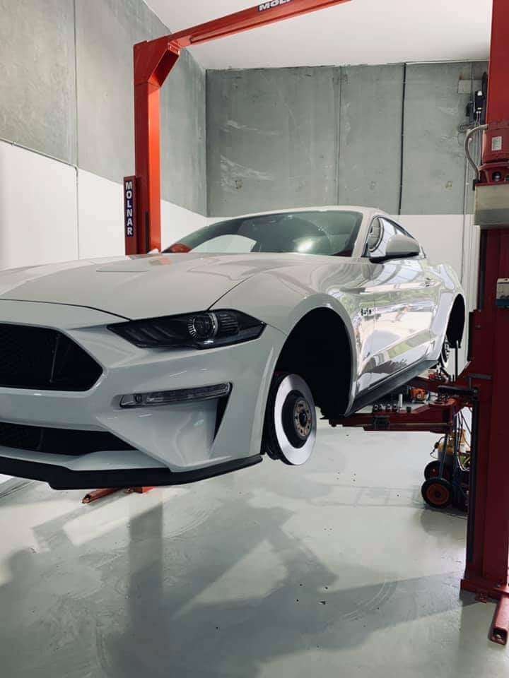 White Mustang lifted on hoist at Castle Hill mechanic