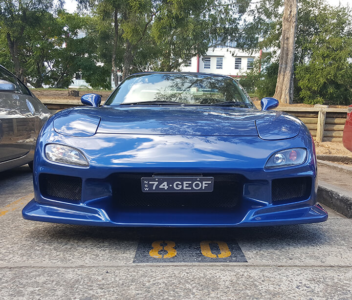 Front of blue RX7 at smash repairs Sydney