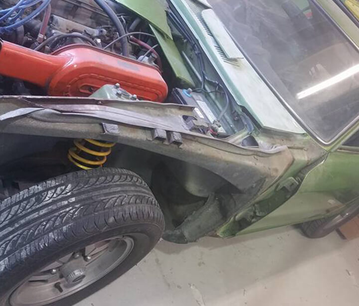 Mid Nissan 240z car restoration with hood up