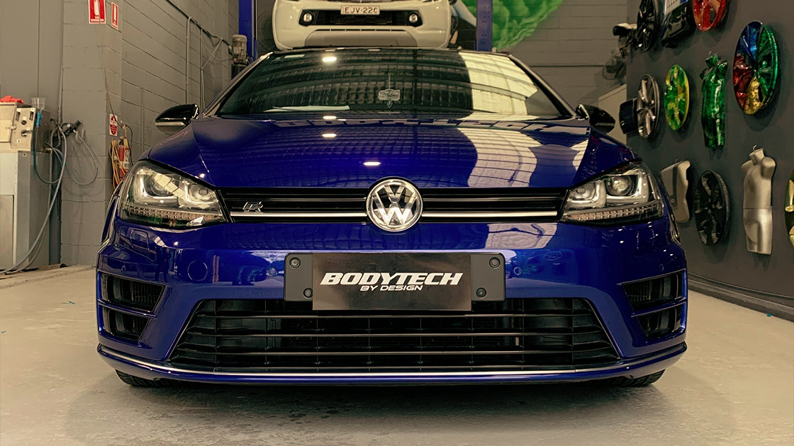 Bodytech Automotive number plate on blue Volkswagen