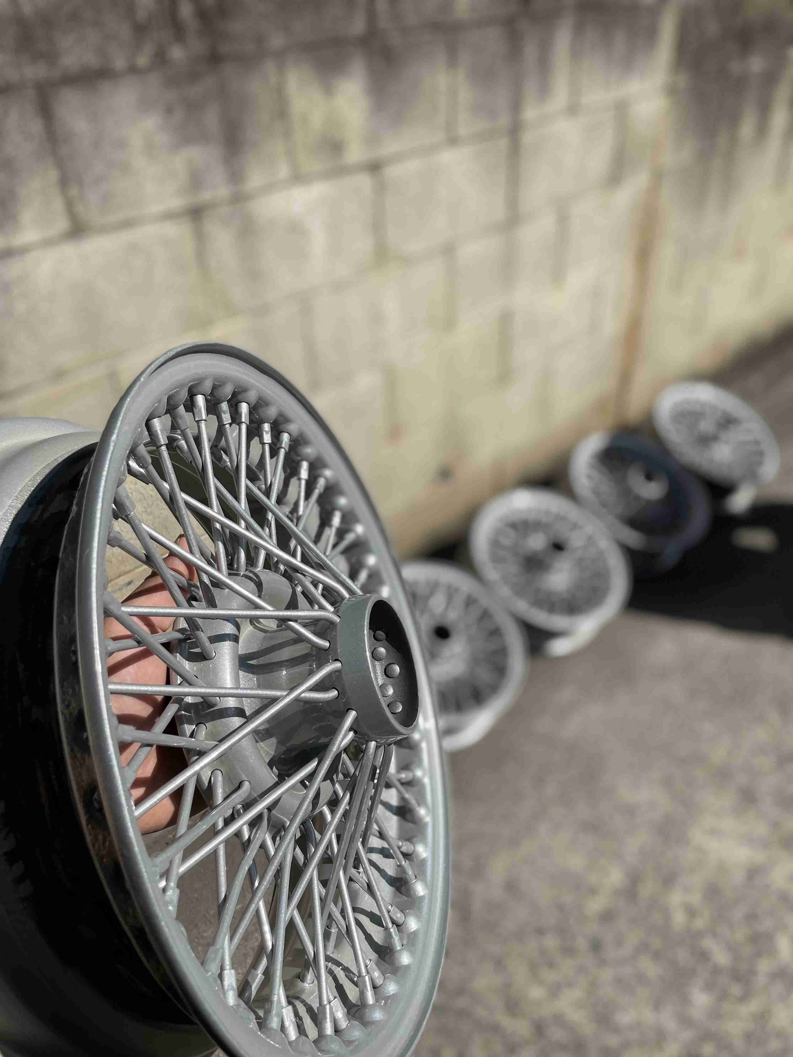 Powder coating of light grey car wheels in Sydney