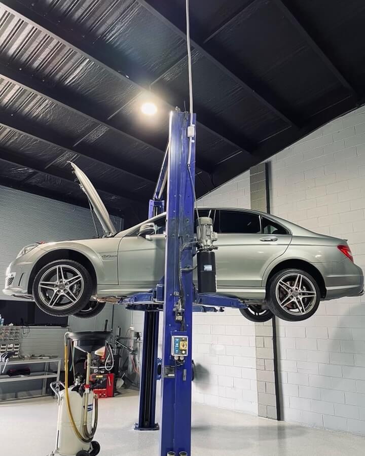 Mercedes on hoist in auto shop for mechanic services Sydney