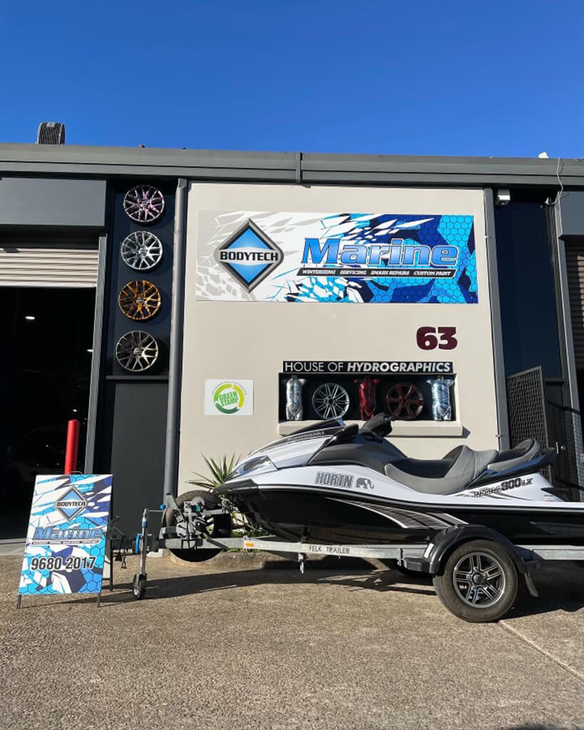 repaired jetski and trailer infront of Bodytech shop