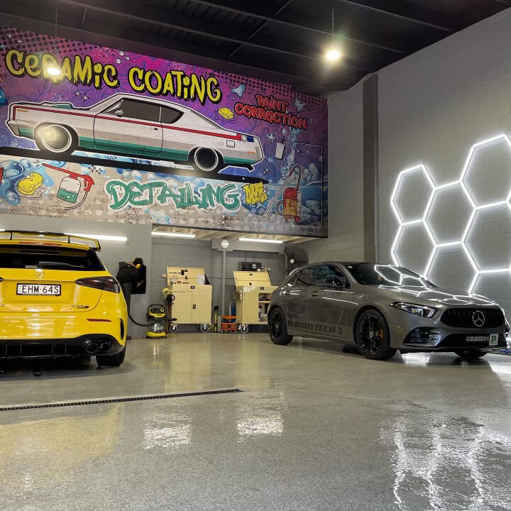 Yellow and grey car inside the ceramic coating detailing shop