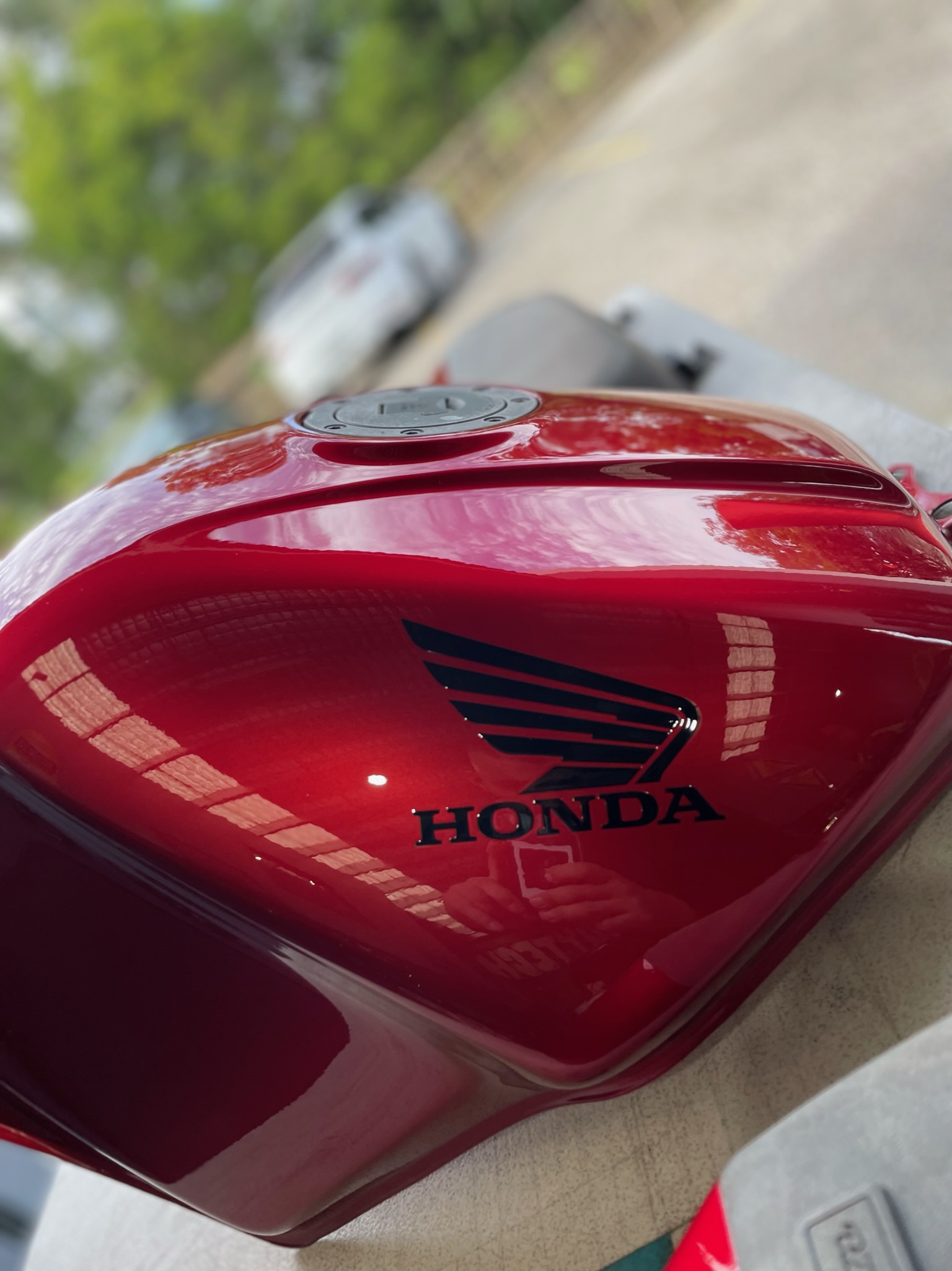 Red Honda motorcycle part spray painted close up